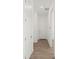 Bright hallway features clean lines, wood-look tile flooring, and white doors at 14587 W Alexandria Way, Surprise, AZ 85379