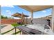 Relaxing hot tub with an adjacent covered patio and lounge area, perfect for unwinding outdoors at 14587 W Alexandria Way, Surprise, AZ 85379