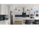 A bright white kitchen with stainless appliances, island, and designer backsplash at 14587 W Alexandria Way, Surprise, AZ 85379