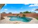A refreshing pool with a rock waterfall and lush green views offers the perfect outdoor retreat at 14587 W Alexandria Way, Surprise, AZ 85379