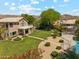 Aerial shot of the beautiful backyard featuring manicured lawn, swimming pool, and desert landscaping at 14655 S 25Th Way, Phoenix, AZ 85048