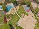 Aerial view of backyard with pool, sport court, patio, desert landscaping, and mature trees at 14655 S 25Th Way, Phoenix, AZ 85048