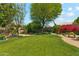 Large backyard showcases lush lawn, desert landscaping, and a comfortable outdoor dining area at 14655 S 25Th Way, Phoenix, AZ 85048