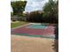 Outdoor basketball court on a sunny day featuring a professional goal with greenery and a crushed gravel surround at 14655 S 25Th Way, Phoenix, AZ 85048