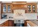 Elegant kitchen showcasing custom cabinetry, stainless steel appliances, and decorative tile backsplash at 14655 S 25Th Way, Phoenix, AZ 85048