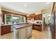 Bright and airy kitchen featuring custom cabinets, an island, stainless steel appliances, and a garden view at 14655 S 25Th Way, Phoenix, AZ 85048