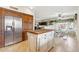Spacious kitchen with center island, stainless steel refrigerator, and open layout to dining area at 14655 S 25Th Way, Phoenix, AZ 85048