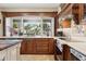 Bright kitchen with a large window above the sink, custom cabinetry, and modern appliances at 14655 S 25Th Way, Phoenix, AZ 85048
