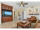 Bright living room featuring a built-in entertainment center and comfortable leather furniture at 14655 S 25Th Way, Phoenix, AZ 85048