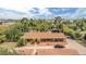 Expansive home featuring lush tree coverage in a suburban setting with an elongated front porch and circular driveway at 154 E Redfield Rd, Chandler, AZ 85225