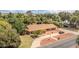 Property aerial view revealing extensive tree coverage, a circular driveway, and a charming ranch-style home at 154 E Redfield Rd, Chandler, AZ 85225