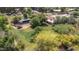 Aerial shot of the property highlighting a large, green backyard, mature trees, and additional structures at 154 E Redfield Rd, Chandler, AZ 85225