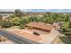 Home's aerial view showcasing the well-manicured circular driveway and extensive tree coverage in a quiet neighborhood at 154 E Redfield Rd, Chandler, AZ 85225