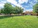 Large, well-maintained backyard with mature trees, offering a serene outdoor space at 154 E Redfield Rd, Chandler, AZ 85225