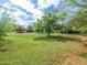 Expansive backyard featuring mature trees and lush green space for outdoor activities and relaxation in a private setting at 154 E Redfield Rd, Chandler, AZ 85225