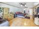 Large bedroom featuring a brick accent wall, tile floors, and two ceiling fans at 154 E Redfield Rd, Chandler, AZ 85225