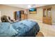 Comfortable bedroom featuring a ceiling fan, tile flooring, and entertainment center at 154 E Redfield Rd, Chandler, AZ 85225