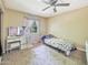 Cozy bedroom features a ceiling fan, vanity table and a sunny window at 154 E Redfield Rd, Chandler, AZ 85225