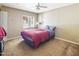 Comfortable bedroom with plush carpet, white window blinds, and a ceiling fan at 154 E Redfield Rd, Chandler, AZ 85225