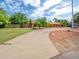 Charming ranch-style home featuring a circular driveway, lush landscaping and mature trees in a welcoming neighborhood at 154 E Redfield Rd, Chandler, AZ 85225