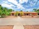 Ranch-style home featuring mature landscaping, a walkway, and a circular driveway at 154 E Redfield Rd, Chandler, AZ 85225