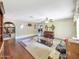Open living room featuring hardwood floors, a wood burning fireplace, and decorative ceiling fan at 154 E Redfield Rd, Chandler, AZ 85225