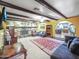 Comfortable living room with a stone fireplace, exposed beams, and an open floor plan at 154 E Redfield Rd, Chandler, AZ 85225