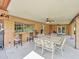 Covered patio area with outdoor seating, ceiling fans, and brick accents at 154 E Redfield Rd, Chandler, AZ 85225