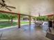 Spacious covered patio with ceiling fans and views of the yard at 154 E Redfield Rd, Chandler, AZ 85225