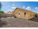 Expansive backyard with a covered patio, shade tree, and low-maintenance landscaping for relaxed outdoor living at 16661 W Belleview St, Goodyear, AZ 85338