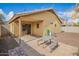 Inviting backyard with a covered patio, picnic table, and low-maintenance landscaping for outdoor enjoyment at 16661 W Belleview St, Goodyear, AZ 85338