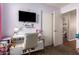 Bright bedroom featuring a modern desk, TV, and stylish decor for a comfortable living space at 16661 W Belleview St, Goodyear, AZ 85338