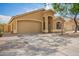 Charming single story home featuring a two car garage, low maintenance landscaping, and a welcoming front porch at 16661 W Belleview St, Goodyear, AZ 85338