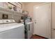 Efficient laundry room with modern washer and dryer, ample storage, and access to the outside at 16661 W Belleview St, Goodyear, AZ 85338