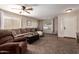 Comfortable living room features carpet floors, ceiling fan, and ample natural light at 16661 W Belleview St, Goodyear, AZ 85338