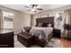 Main bedroom featuring neutral walls, ceiling fan, tufted headboard, area rug and dresser at 16661 W Belleview St, Goodyear, AZ 85338