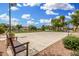 A community basketball court with seating surrounded by grass, landscaping, and residential buildings at 1689 E Elgin St, Gilbert, AZ 85295
