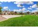 A view of the community basketball court surrounded by grassy fields and neighborhood homes at 1689 E Elgin St, Gilbert, AZ 85295
