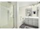 Bright bathroom with gray cabinets, soaking tub, glass enclosed shower, and dual sinks at 1689 E Elgin St, Gilbert, AZ 85295