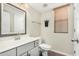 Well-lit bathroom with gray vanity, framed mirror, and a shower-tub combination at 1689 E Elgin St, Gilbert, AZ 85295