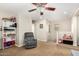 Upstairs bonus room with neutral carpet, ceiling fan, and additional seating at 1689 E Elgin St, Gilbert, AZ 85295
