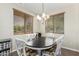 Cozy dining area with a round table, white chairs, and wood blinds at 1689 E Elgin St, Gilbert, AZ 85295
