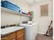 Bright laundry room featuring a sink, washer, dryer, overhead shelf for supplies, and tiled floor at 1689 E Elgin St, Gilbert, AZ 85295