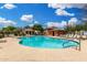 Sparkling pool with lounge chairs and clubhouse under a sunny sky at 1689 E Elgin St, Gilbert, AZ 85295