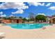 Sparkling pool with lounge chairs and clubhouse under a sunny sky at 1689 E Elgin St, Gilbert, AZ 85295