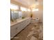 Elegant bathroom featuring dual sinks, white cabinetry, quartz countertop, soaking tub, and modern fixtures at 17911 N Adobe Mesa Ct, Surprise, AZ 85374