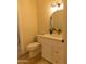 Chic powder room features modern vanity, stylish mirror, and elegant fixtures, maximizing space and style at 17911 N Adobe Mesa Ct, Surprise, AZ 85374