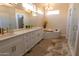 Elegant bathroom featuring dual sinks, white cabinetry, quartz countertop, soaking tub, and modern fixtures at 17911 N Adobe Mesa Ct, Surprise, AZ 85374