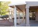 Spacious covered patio with pillars and a walkway to the backyard at 17911 N Adobe Mesa Ct, Surprise, AZ 85374