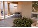 Cozy covered patio featuring outdoor seating and a charming garden at 17911 N Adobe Mesa Ct, Surprise, AZ 85374